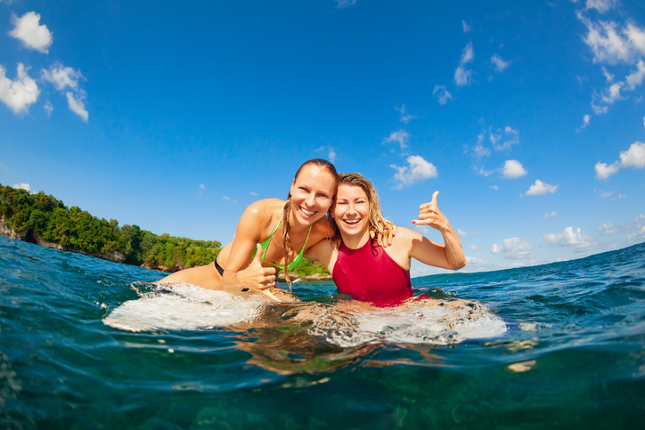 Happy girls getting surf lessons in Haleiwa