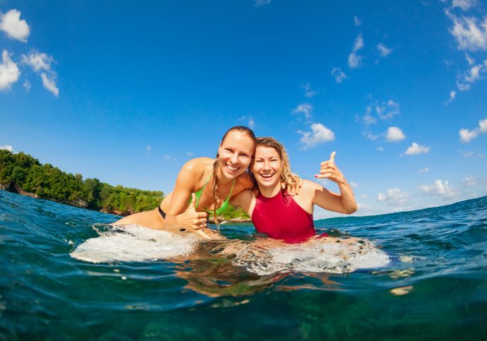 Happy girls getting surf lessons in Haleiwa